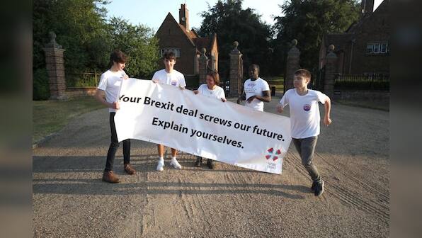 May wins support from divided UK government on Brexit plan