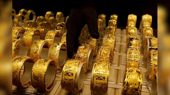 Gold falls as dollar, equities gain on U.S.-China truce