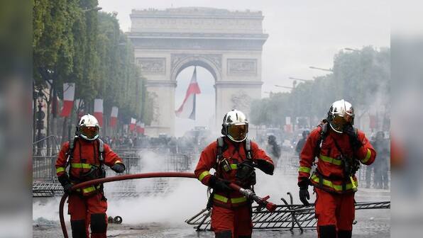 French police fire tear gas as protests follow Bastille Day parade