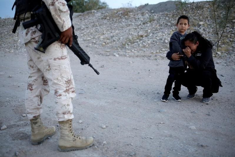 Reuters photo captures Guatemalan mother begging soldier to let her enter US