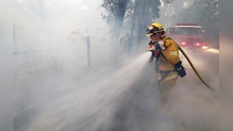 Crews battling deadly California wildfire slowed by returning winds