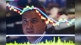 Wall Street sinks as yuan slide inflames U.S.-China trade dispute