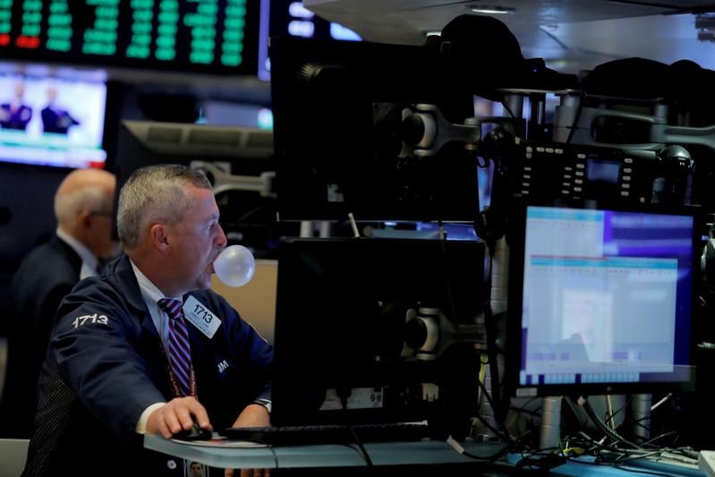 Wall Street slips as financials drag trade outlook clouds