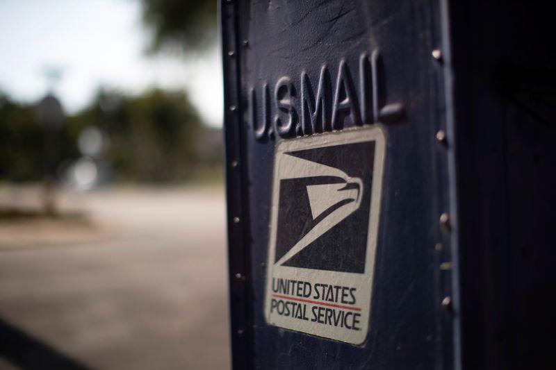 US Postal Service puts changes on hold after mailin voting outcry