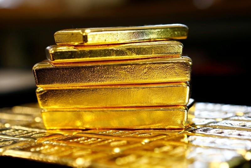 Gold gains on sliding dollar shortcovering