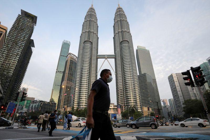Malaysia says no more fist bumps as coronavirus numbers jump