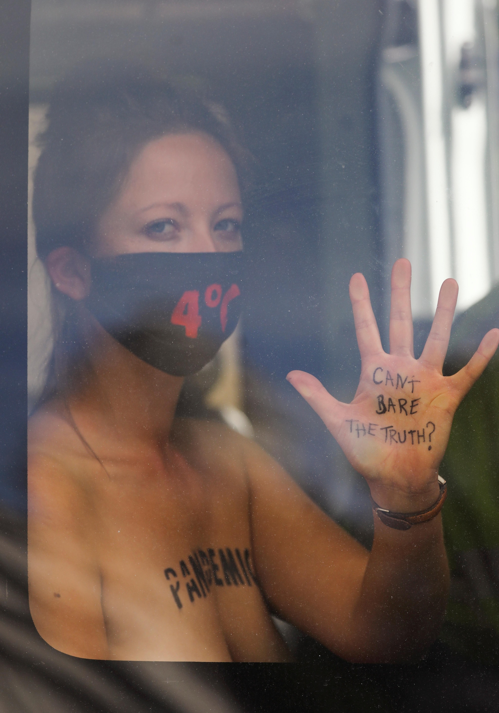 Barechested women lock themselves to UK parliament in climate protest