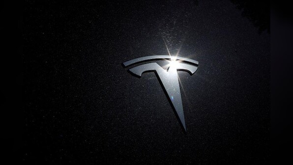 Tesla's Elon Musk promises dramatic cuts in electric car costs, but investors must wait