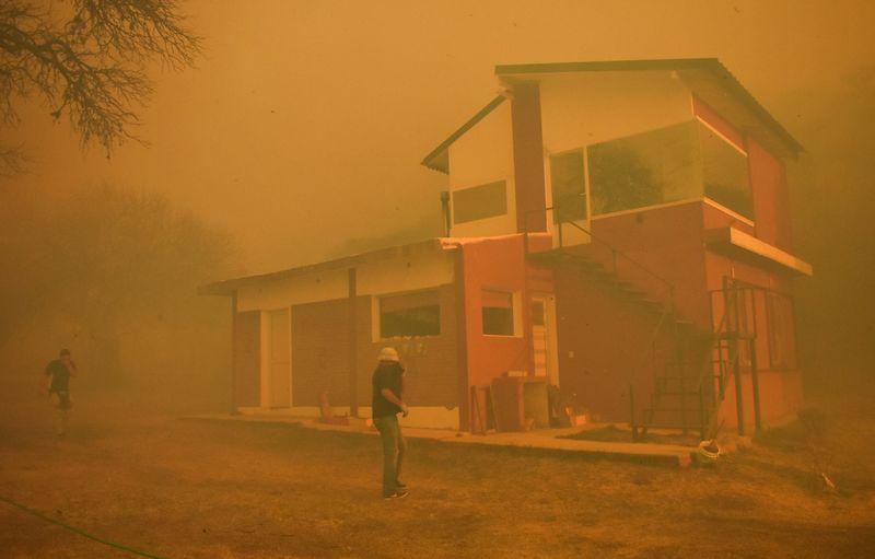 In Argentinas ranch heartlands dry winds fan blazes as firefighters battle for control