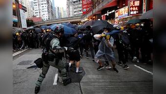 China's military warns protesters they may be arrested for targeting Hong Kong barracks with laser light