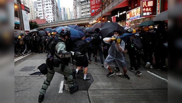 China's military warns protesters they may be arrested for targeting Hong Kong barracks with laser light