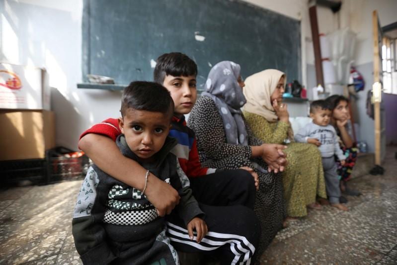 Kurdish families stuck in crowded schools after fleeing north Syria conflict