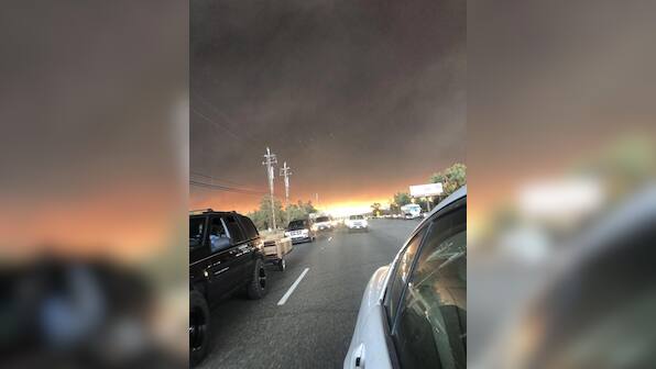 Grieving after shooting, California city threatened by wildfires