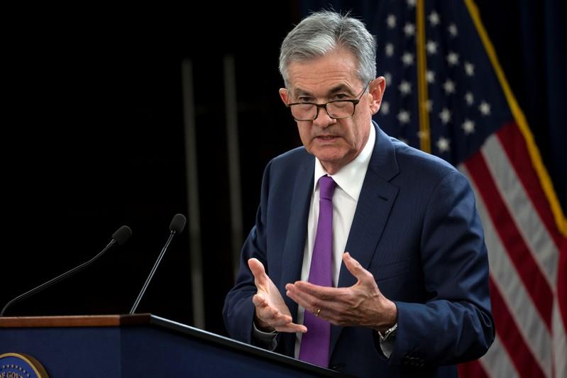 Powell backs rate hikes says financial risks contained