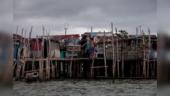 Rising seas threaten early end for sinking village in Philippines