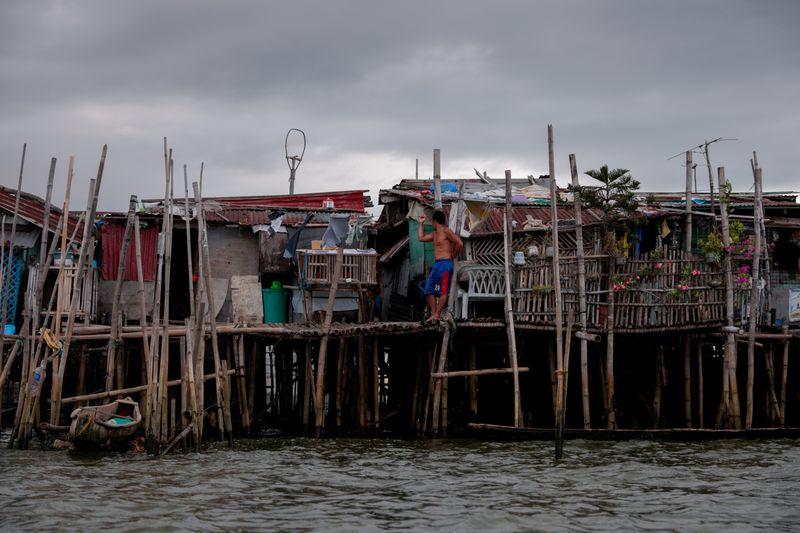 Rising seas threaten early end for sinking village in Philippines Rising seas threaten early end for sinking village in Philippines