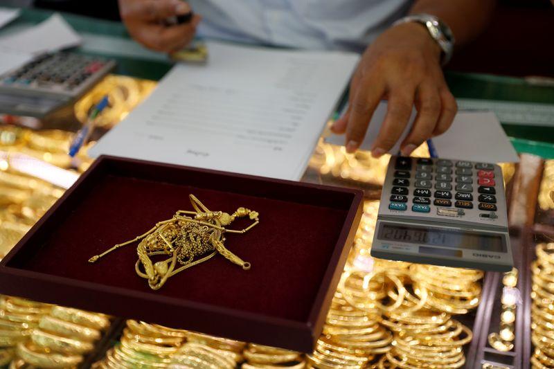 Gold falls to 4month low as stocks jump on strong US data