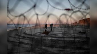 Tired of waiting for asylum, migrants from caravan breach U.S. border