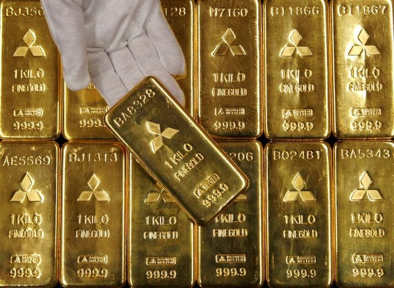 Gold eases to 1week low as dollar stocks gain